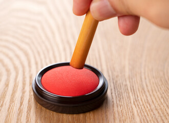 Red ink and seal on a wooden background