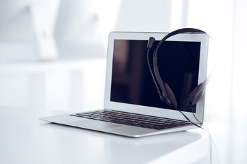 Call center and communication support, customer service help desk. VOIP headset on laptop computer