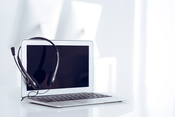 Fototapeta premium Call center and communication support, customer service help desk. VOIP headset on laptop computer
