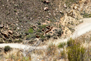 Naklejka na ściany i meble The winding Swartberg Pass near Oudtshoorn showing the arid landscape and twisty road that leads to the Little Karoo.