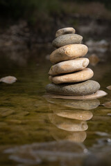 Pebble stone construction in river. Calm, zen and tranquility.