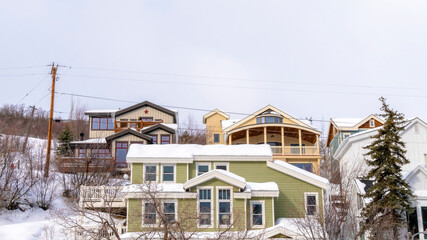 Panorama Homes on snowy residential mountain slope in scenic Park City Utah in winter