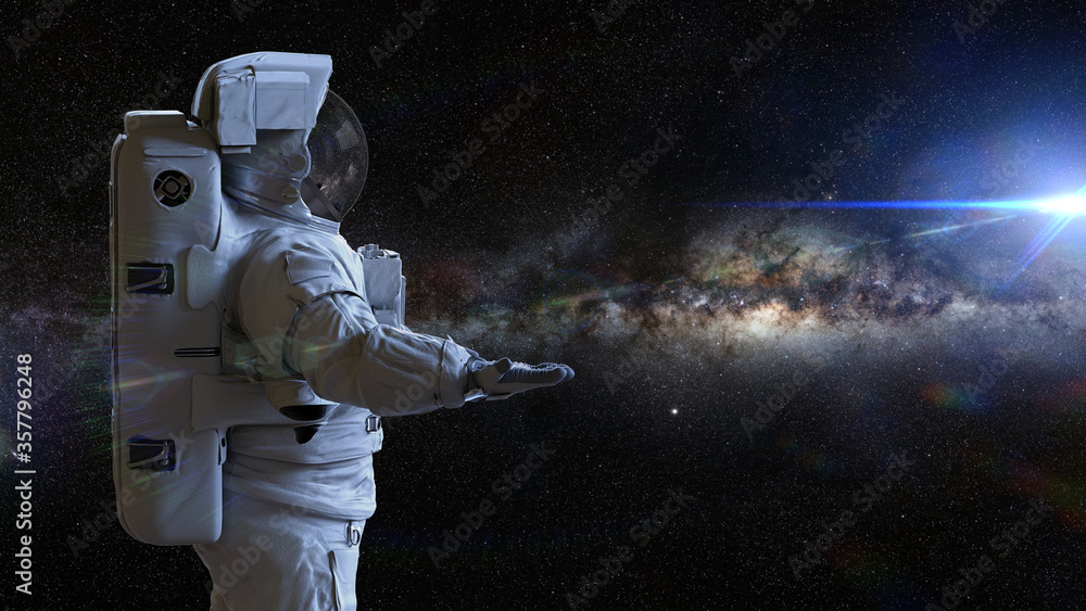 Wall mural astronaut presenting an empty space in front of the milky way galaxy