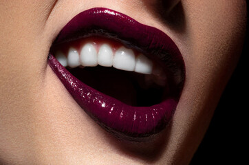 Beautiful female lips with burgundy makeup close-up