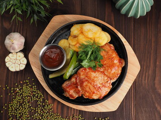 Grilled pork escalope with BBQ sauce and potato slices