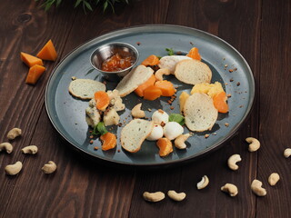Cheese assortment plate on a dark wooden table