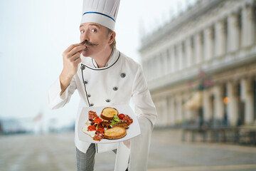 Chef cook with a fast food on a plate on a street city