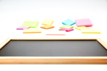 Empty black board next to colored post-it