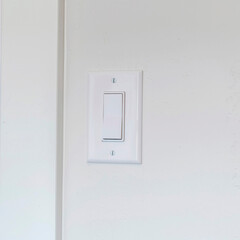 Square frame Indoor electrical light switch of home mounted on white wall background