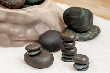 Set of stacks hot massage stones on a towel in spa.