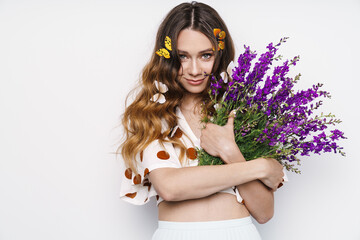 Photo of woman with fake butterflies and flowers smiling at camera