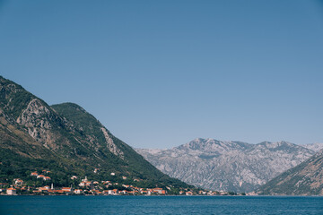 Fototapeta na wymiar Kotor Bay in Montenegro. Sea water at the foot of the mountains.
