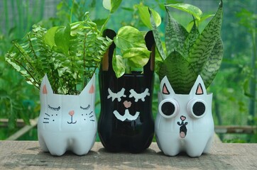 Recycled colored flower pots made of used plastic bottles. Nice decoration for inside and outside.