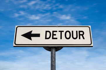 Detour road sign, arrow on blue sky background. One way blank road sign with copy space. Arrow on a pole pointing in one direction.