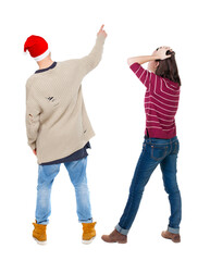 Back view of couple in sweater pointing.