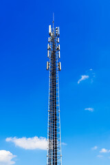 Telecommunication tower with 5G cellular network antenna. Cell Phone Signal tower on sky background.
