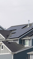 Vertical House exterior in South Jordan Utah with view of solar panels on the gray roof