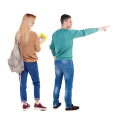 Obraz premium Back view of couple in sweater pointing.
