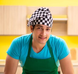 Young professional cook preparing in kitchen