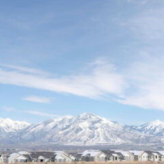 Fototapeta na wymiar Square crop Striking Wasatch Mountains and South Jordan City in Utah during winter season