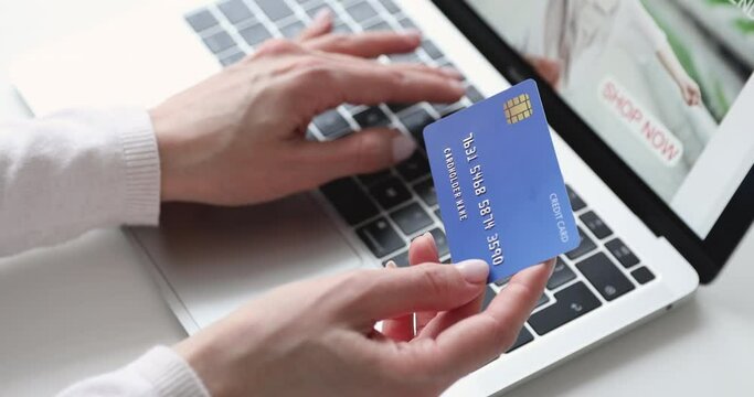 Close up young woman entering banking credit card information, purchasing goods or services online. Female shopper making payments in internet store on computer application, ecommerce concept.