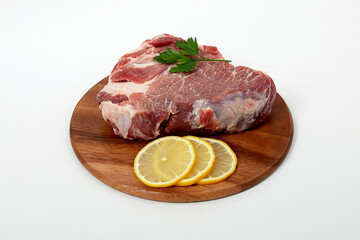 a piece of raw meat pork on a wooden backing