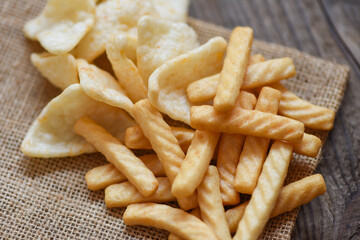 crunchy prawn crackers or shrimp crisp rice and ketchup for traditional snack - prawn crackers stick on sack and wooden table background