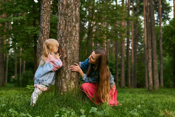 mom and daughter play and have fun in the park