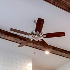 Square Wood beams and recessed bulbs with ceiling fan and lights at the center