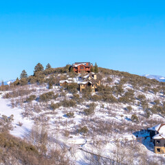 Square Scenery of homes on snow covered mountain top against blue sky in Park City Utah