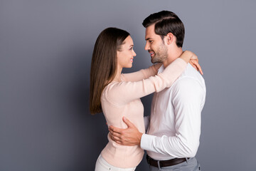 Profile side view portrait of his he her she nice attractive lovely cute lovable cheerful tender sweet couple embracing isolated over gray violet purple pastel color background
