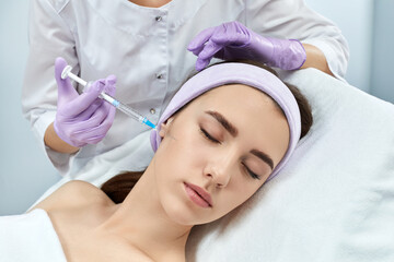 beautiful woman getting beauty injections in her face. cosmetology