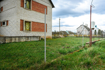 Rabitz fence on a background of green grass.