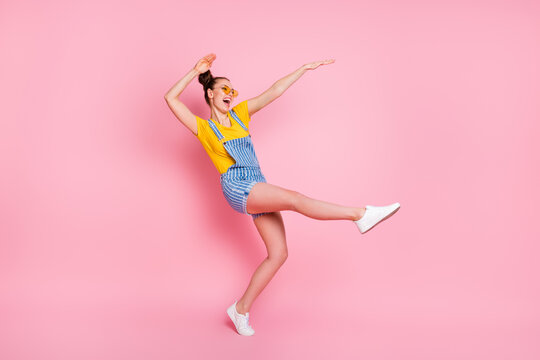 Full length body size view of her she nice attractive pretty funky cheerful cheery glad brown-haired girl jumping fooling dancing having fun chill out clubbing isolated on pink pastel color background