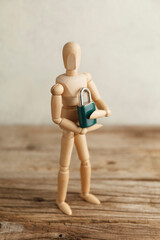 Toy man holds lock in his hands as a symbol of individual privacy, a secret. Intellectual property...