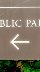 Vertical No Public parking sign with arrow at the Receiving area outside a building