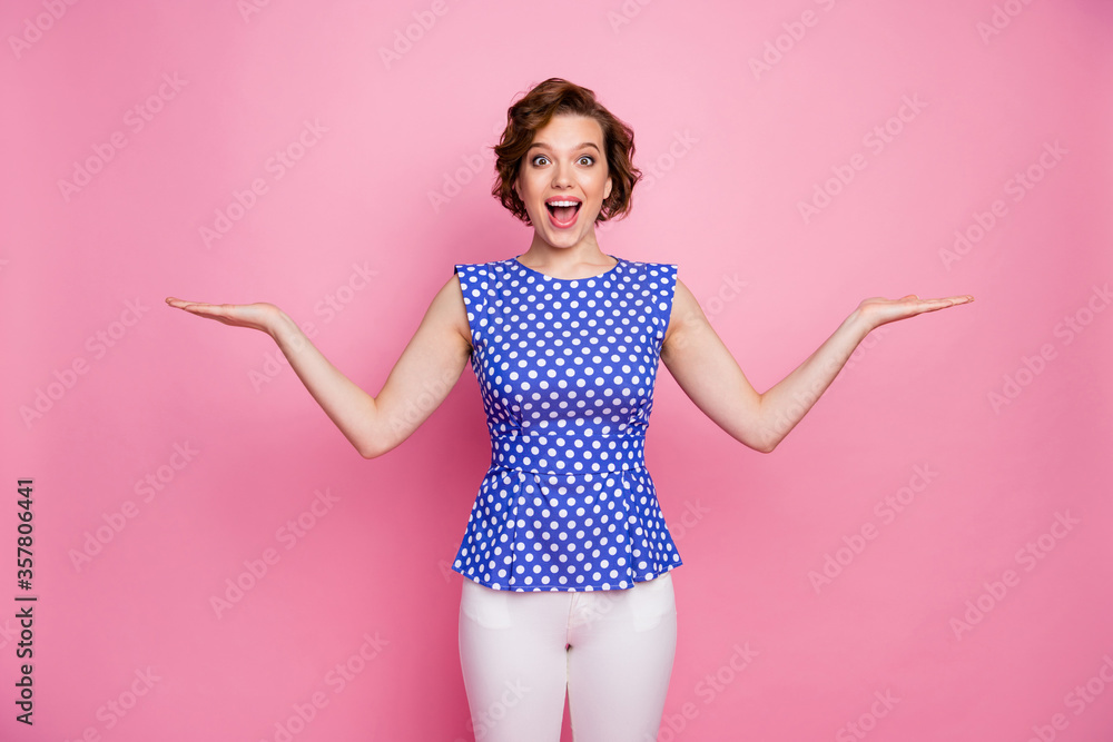 Wall mural Portrait of her she nice attractive lovely pretty glad excited positive cheerful cheery brown-haired girl holding copy space on palms pros cons isolated over pink pastel color background