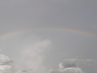 view of rainboaw with soft raining and cloudy sky background.