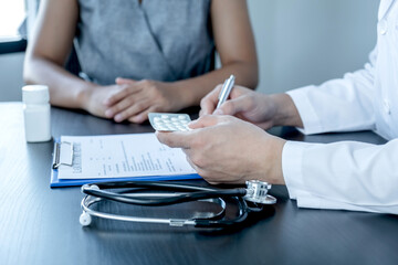 Male doctors explain and recommend treatment with a prescription after the patient meets a doctor and receives results regarding illness problems