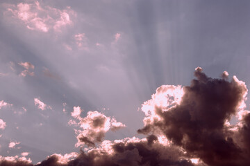 Black and white clouds with sun rays in the sky