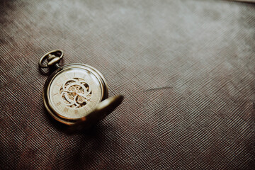 old clock with shackle on brown background