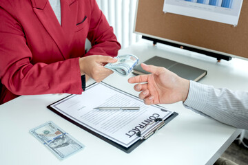 A photo of a businessman who gives money to his partner to bribe the idea of ​​bribery and...