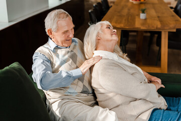 happy elderly couple doing massage and relaxing at home on self isolation