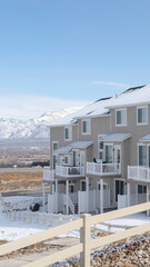 Fototapeta na wymiar Vertical frame Peaceful neighborhood in South Jordan City with view of distant Wasatch Mountain
