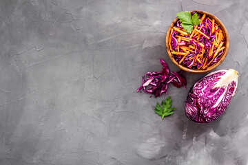 Healthy vegan salad with red cabbage on grey kitchen table top view copy space