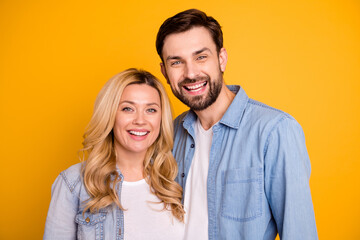 Photo pretty wife lady handsome husband guy couple hugging ignore social distancing good mood in love perfect pair wear casual denim shirts clothes isolated yellow color background