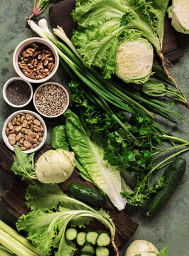 Healthy vegan food with vegetables nuts seeds and cereals top view Cooking green eating concept