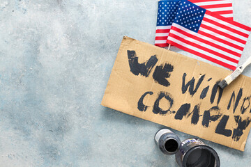 Protests concept. Phrase we will not comply written on cardboard overhead view