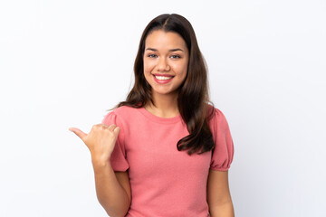 Fototapeta premium Young Colombian girl over isolated white background pointing to the side to present a product