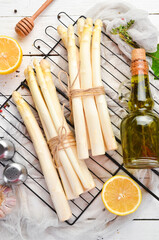 Organic white asparagus on a white wooden background. Healthy food. Top view. Free space for your text.